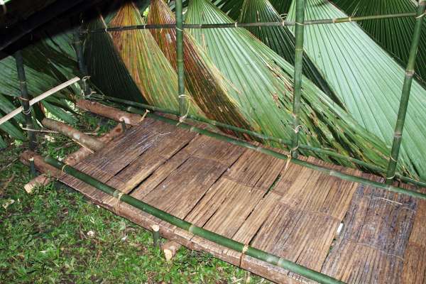 Interior of a newly constructed birthing hut, with bamboo and timber stretcher for the mother.