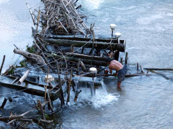 Water levels can rise suddenly in Kri lands due to heavy rains in steep-sided watersheds. Here a villager at Mrka Kơn Hamlet removes his pico-hydro unit in anticipation of damaging waterflow due to rain.