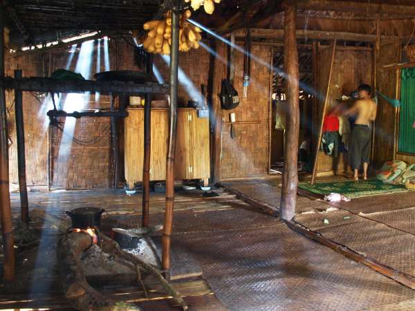 Interior of a Kri home in the morning; father is boiling water for tea before heading to his fields