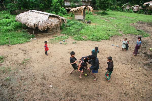 A pomelo fruit serves as a soccer ball for these Kri children.